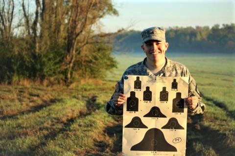 Cadet holding sign.