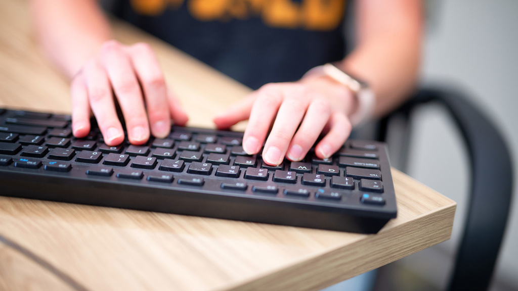 Iowa student typing on keyboard.